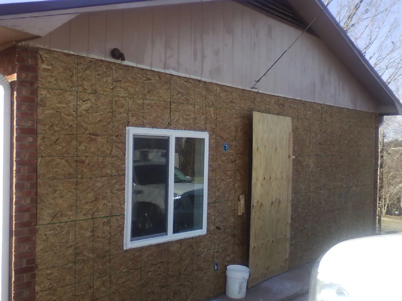 OSB sheathing on a garage addition wall before siding in Oxford